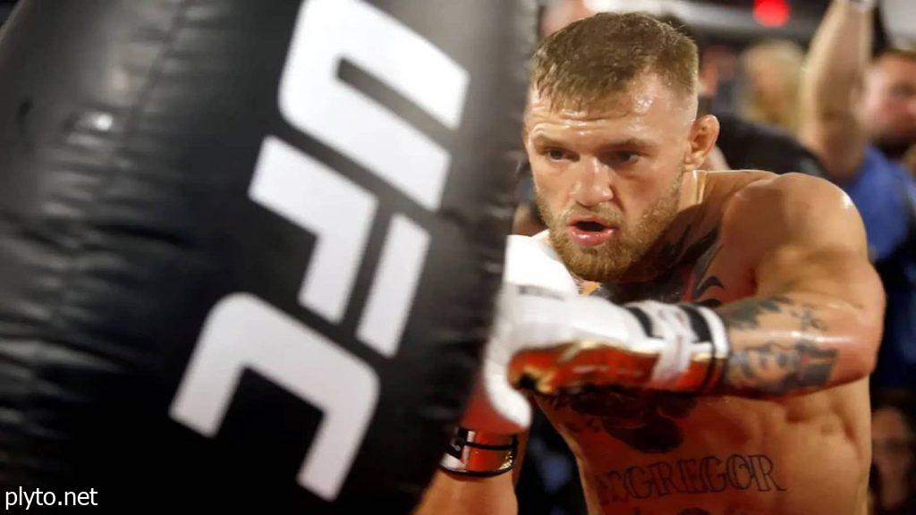 A mixed martial artist training in the gym, showcasing intense focus and dedication ahead of a major fight in UFC 2024.