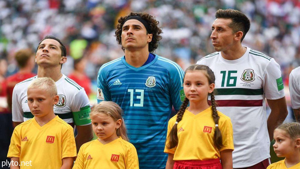 Andres Guardado in action, dribbling past an opponent, showcasing his skill and agility on the field.