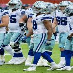 Dallas Cowboys huddle during a tense game, showcasing team dynamics amid struggles.