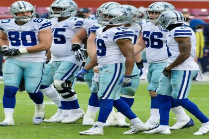 Dallas Cowboys huddle during a tense game, showcasing team dynamics amid struggles.