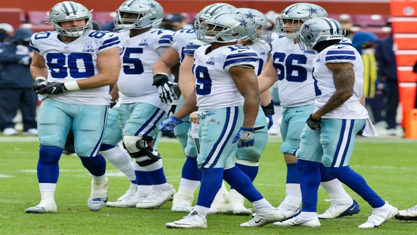 Dallas Cowboys huddle during a tense game, showcasing team dynamics amid struggles.