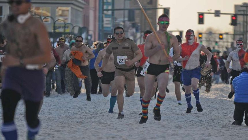 Runners in spooky costumes participate in a Halloween 5K race event.