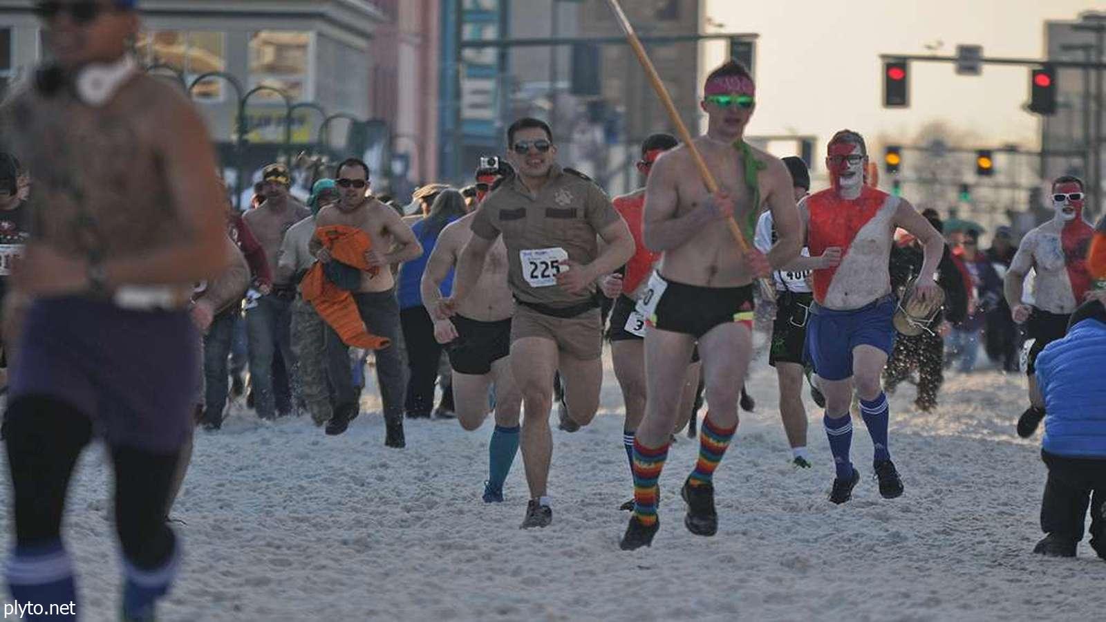 Runners in spooky costumes participate in a Halloween 5K race event.