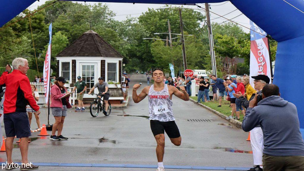 Participant in skeleton costume sprinting during a Halloween 5K race.