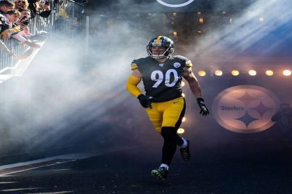 Pittsburgh Steelers players celebrating a touchdown scored by Russell Wilson.