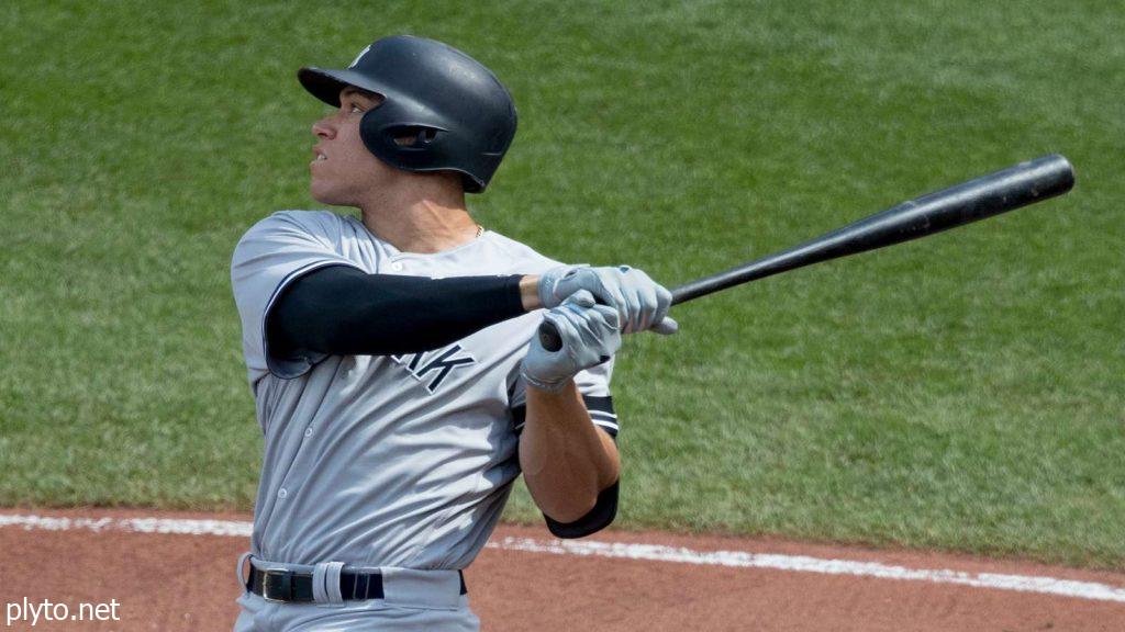 Aaron Judge walking off the field after a tough game, reflecting the challenges and expectations faced by the star player in the competitive MLB postseason.