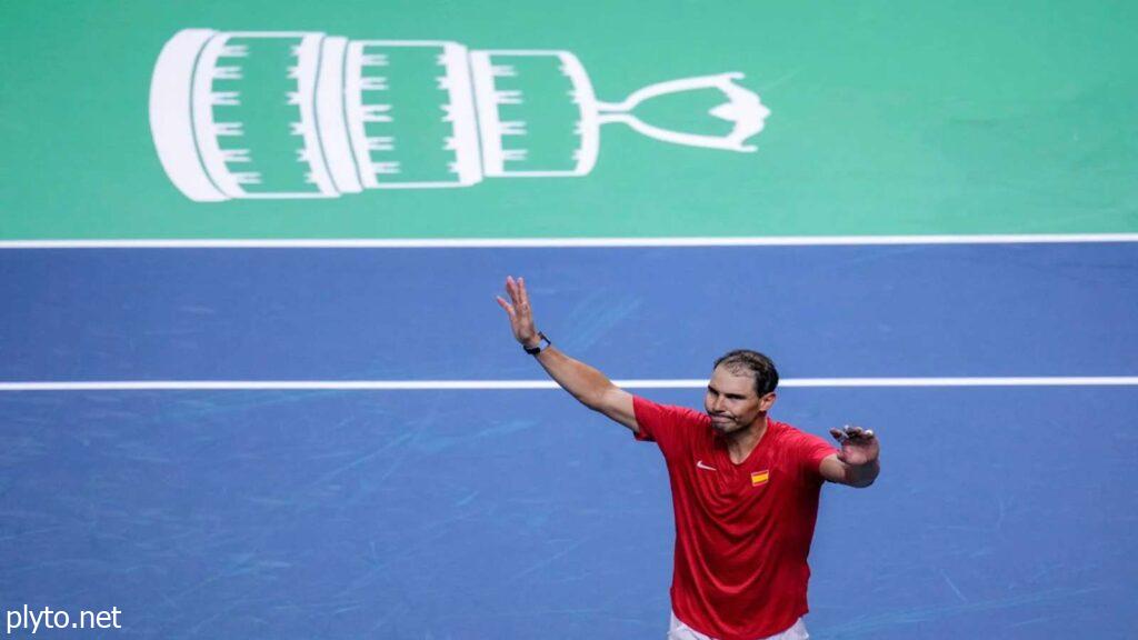 Rafael Nadal holding his racket in his iconic sleeveless shirt and bandana