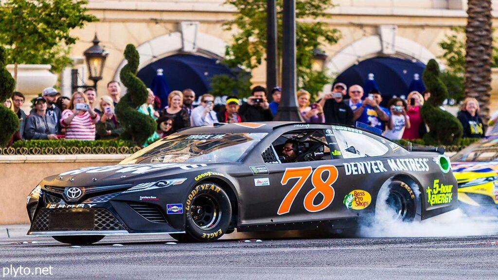 Martin Truex Jr. racing for Joe Gibbs Racing during a NASCAR event.