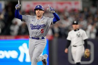 Team Unity: The Dodgers team posing together on the parade float, showcasing their unity and joy after winning the World Series.