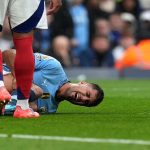 Manchester City manager Pep Guardiola discussing injury concerns at a press conference