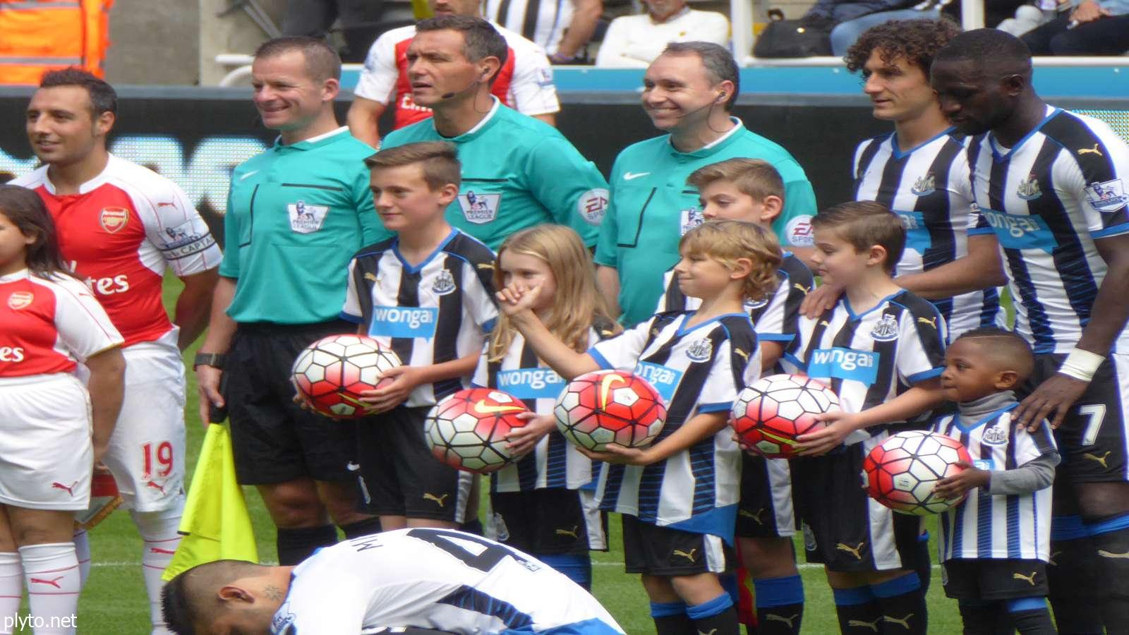 Exciting moment from the Newcastle vs. Arsenal match at St. James' Park, showcasing passionate fans cheering for their teams.